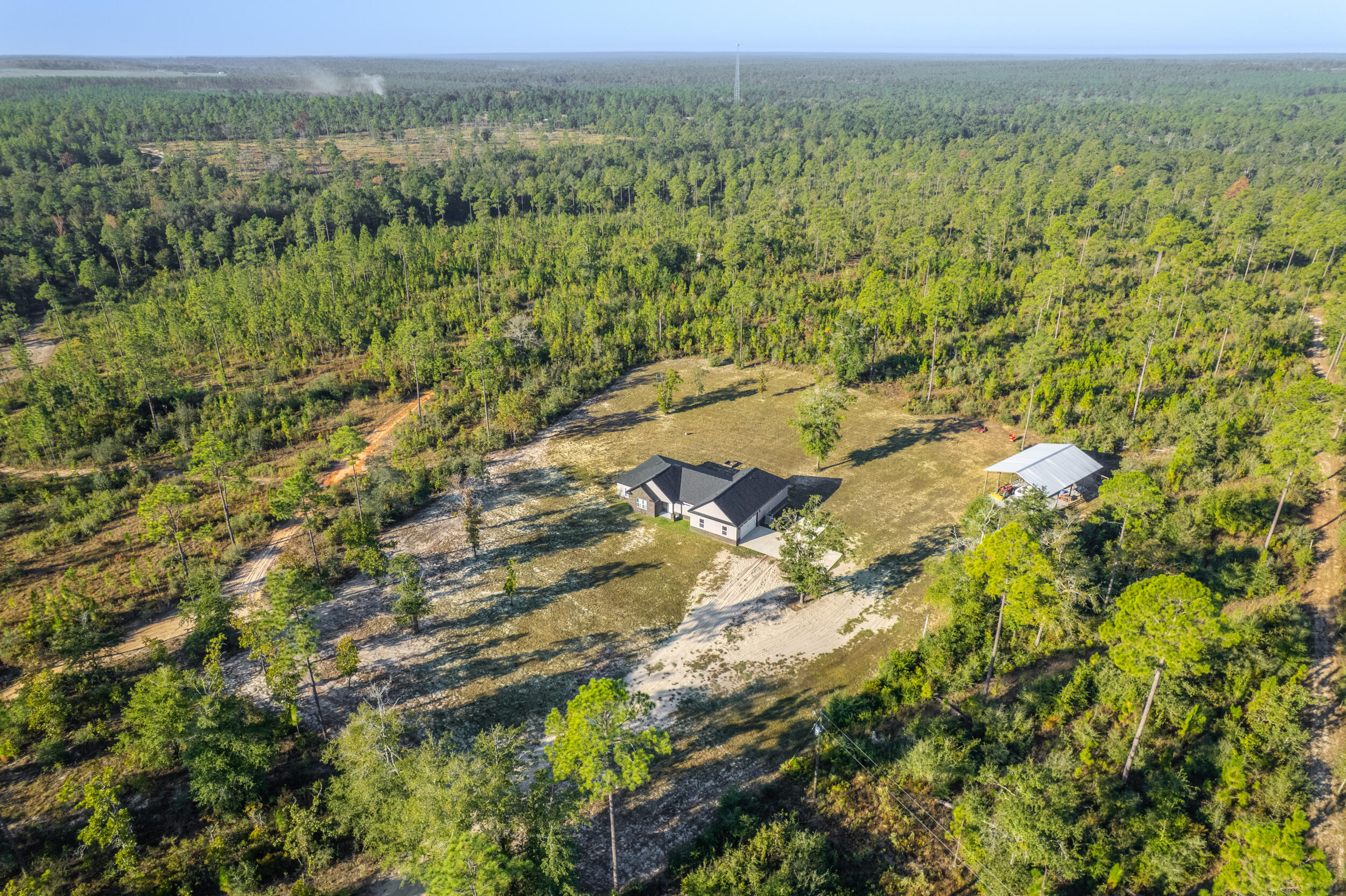 6150 Sherman Kennedy Road Baker, FL 32531 - Photo 34 of 43 an aerial view of residential houses with outdoor space and trees