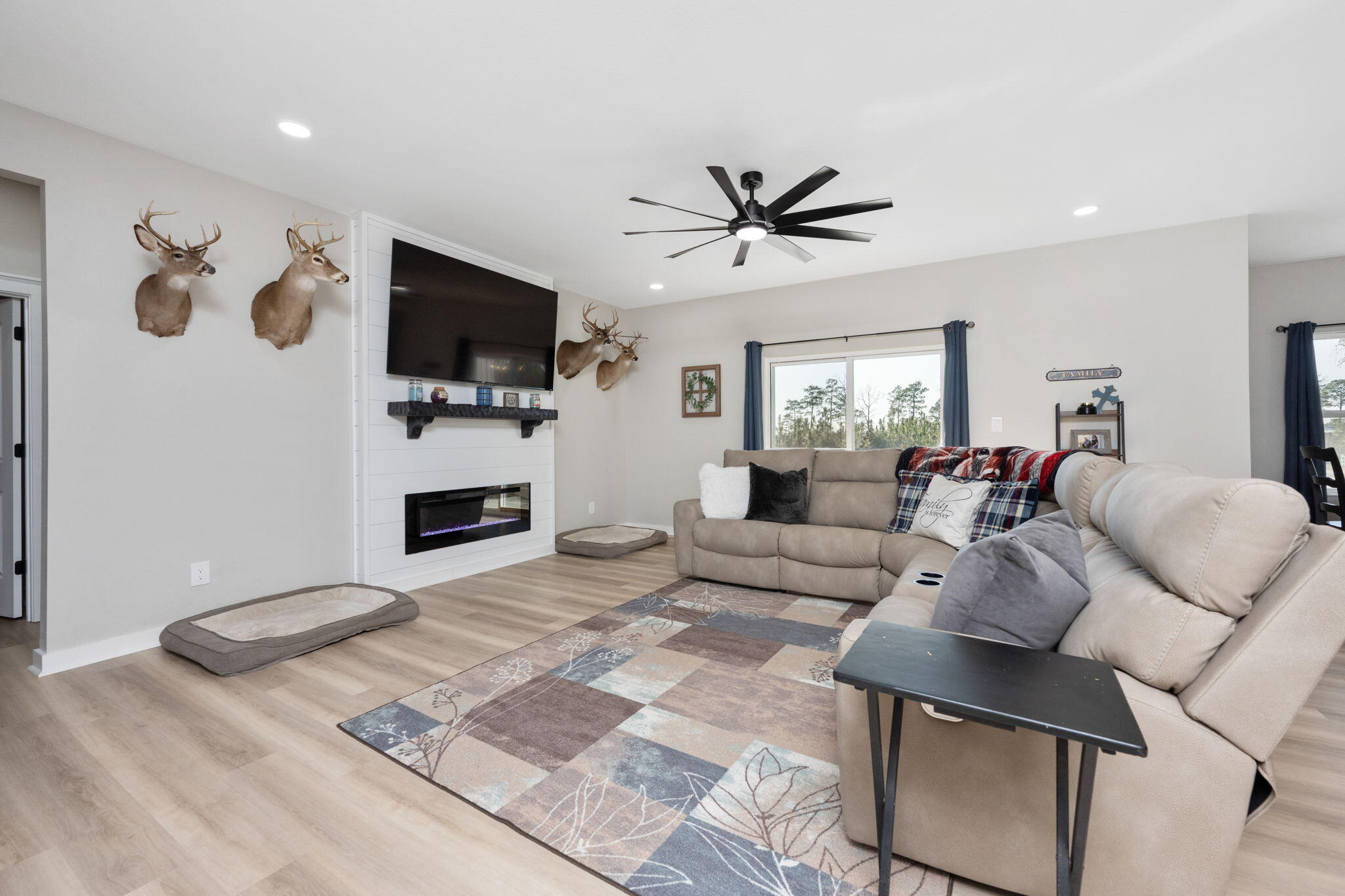 6150 Sherman Kennedy Road Baker, FL 32531 - Photo 6 of 43 a living room with furniture a flat screen tv and a fireplace