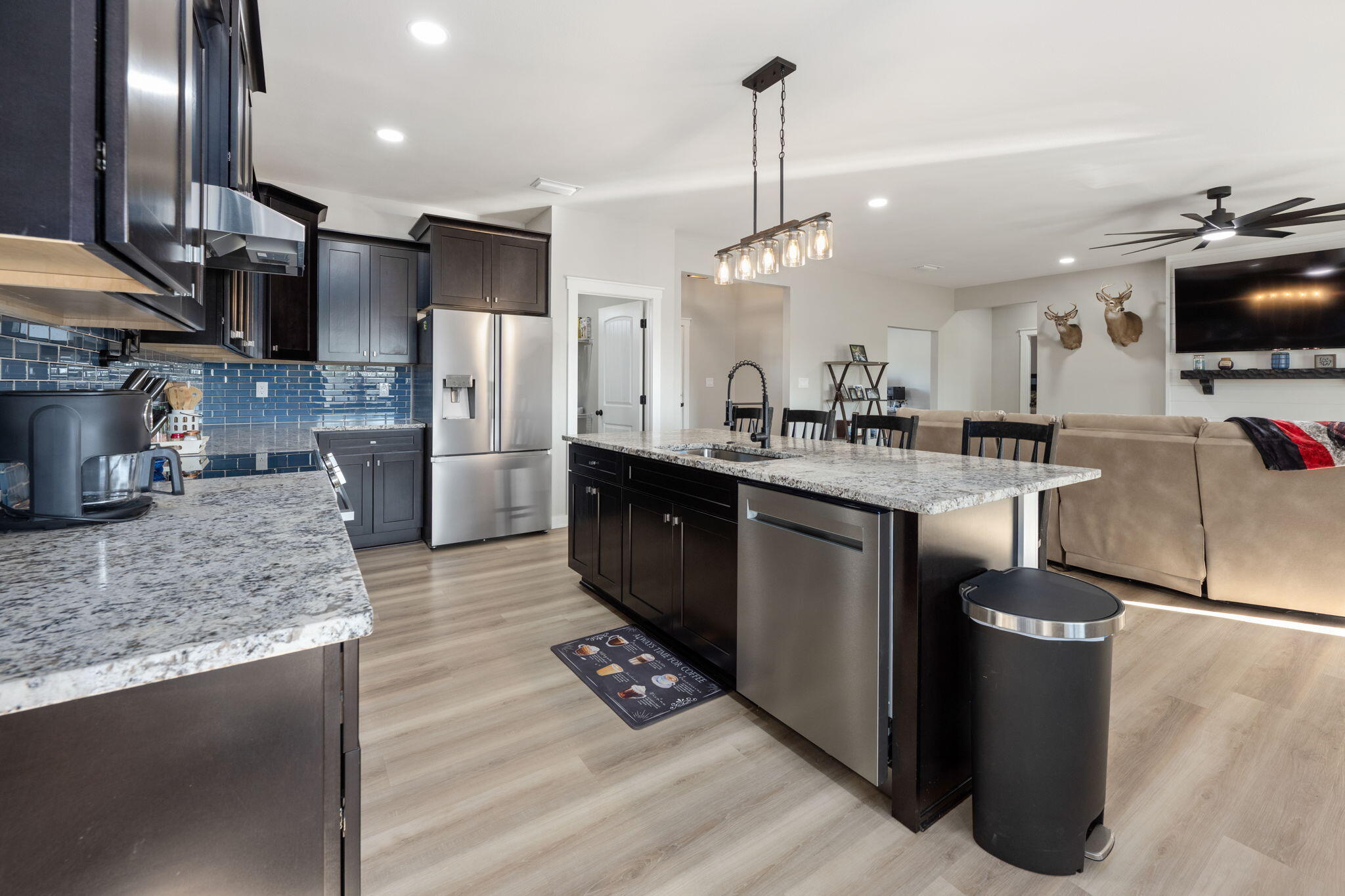6150 Sherman Kennedy Road Baker, FL 32531 - Photo 9 of 43 a kitchen with stainless steel appliances granite countertop a sink a stove and a refrigerator
