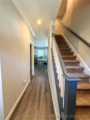 a view of entryway and hall with wooden floor