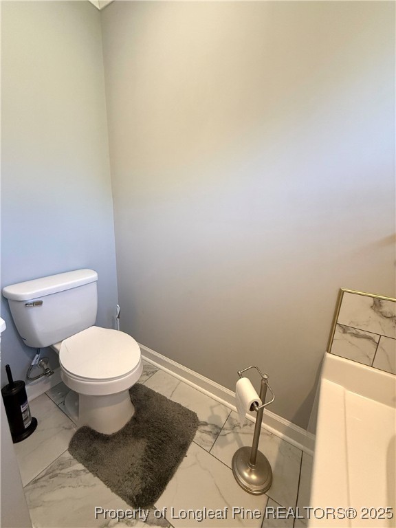 171 Apache Trail Sanford, NC 27332 - Photo 33 of 37 a bathroom with a toilet and a sink