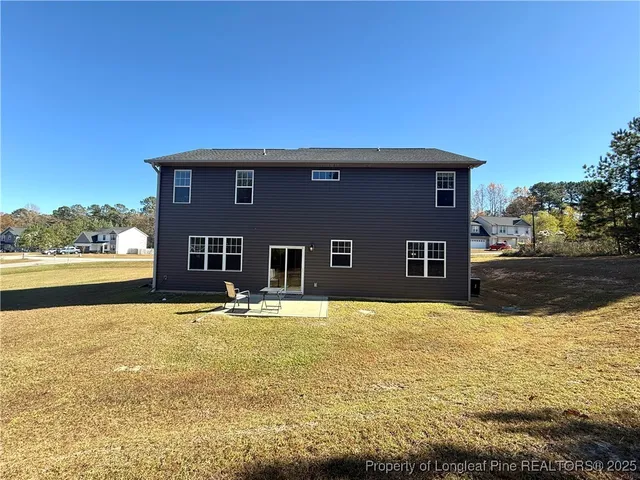 a house view with swimming pool and a yard