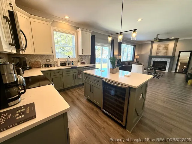 a kitchen with a sink stove and wooden floor