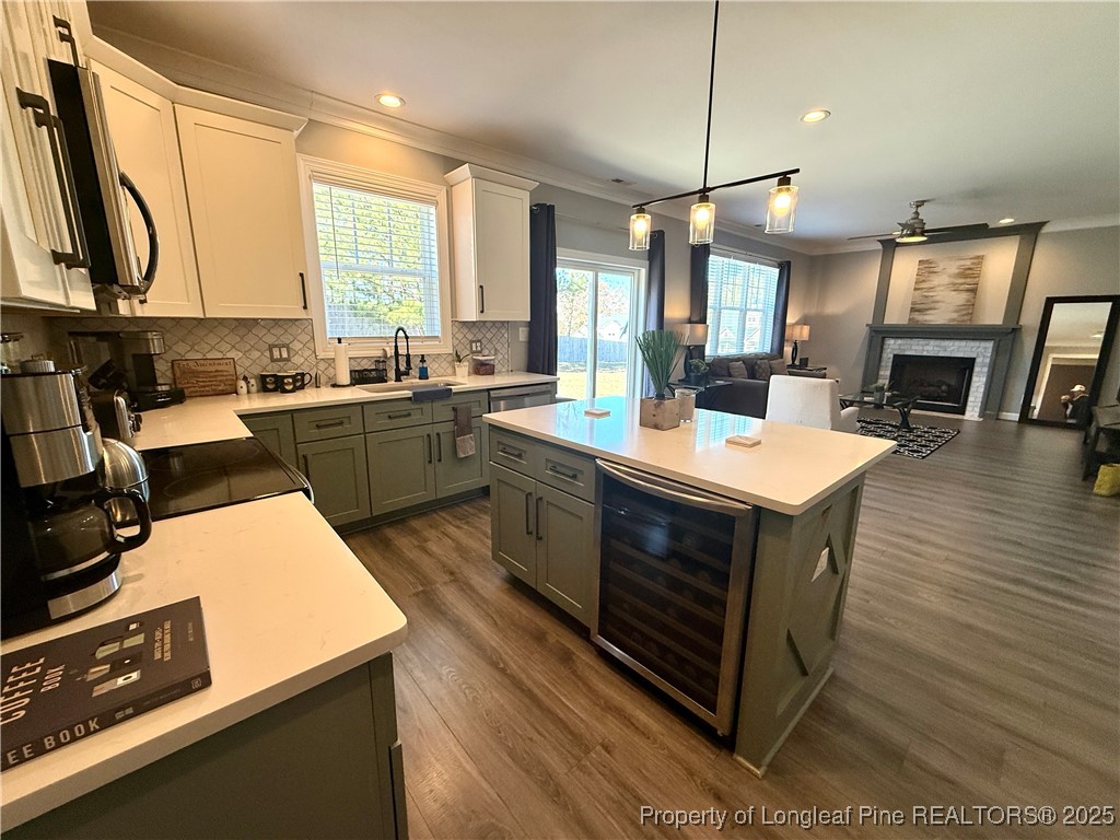 171 Apache Trail Sanford, NC 27332 - Photo 9 of 37 a kitchen with a sink stove and wooden floor