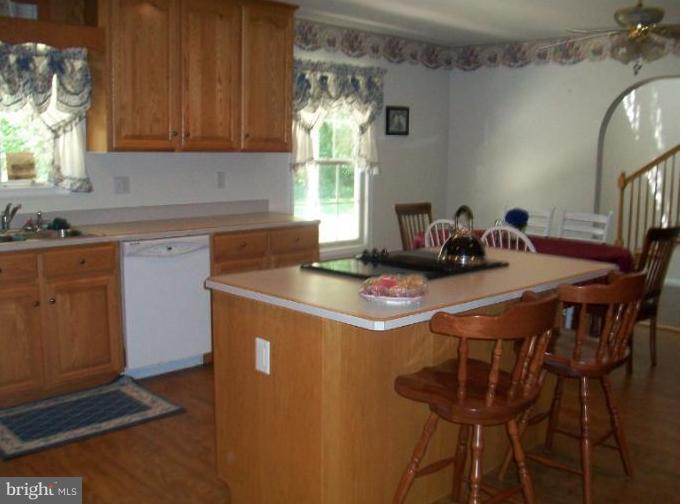 31430 Chesterville Bridge Road Millington, MD 21651 - Photo 6 of 14 table area between island and arched opening