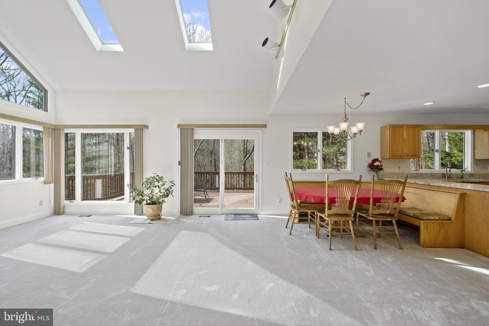 6251 Stephen Reid Road Huntingtown, MD 20639 - Photo 13 of 46 a living room with a large window a table and chairs
