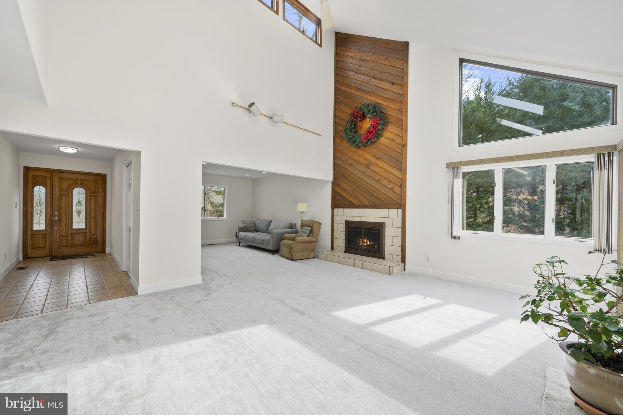 6251 Stephen Reid Road Huntingtown, MD 20639 - Photo 14 of 46 a view of a livingroom with a fireplace and a potted plant