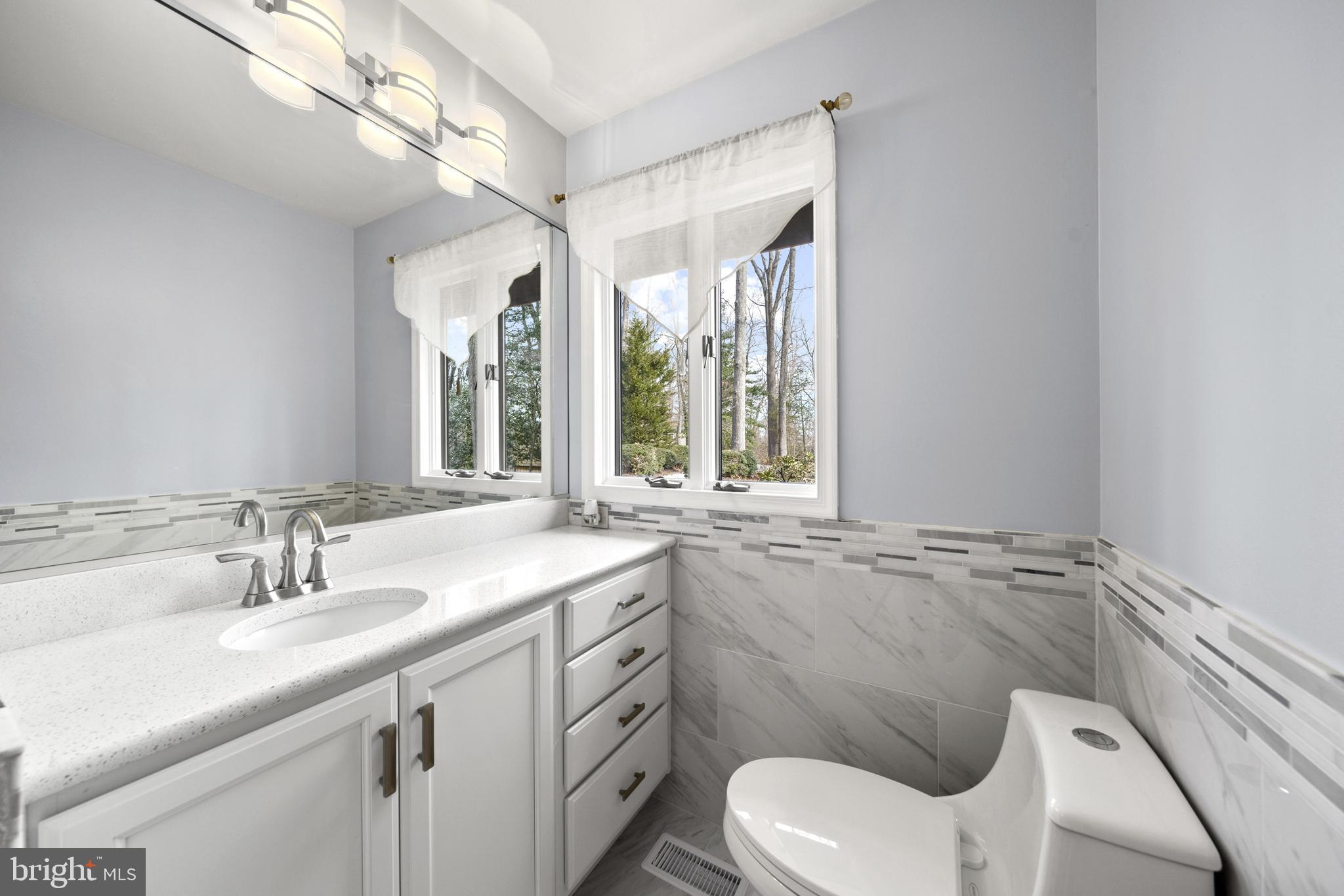 6251 Stephen Reid Road Huntingtown, MD 20639 - Photo 23 of 46 a bathroom with a sink toilet and window