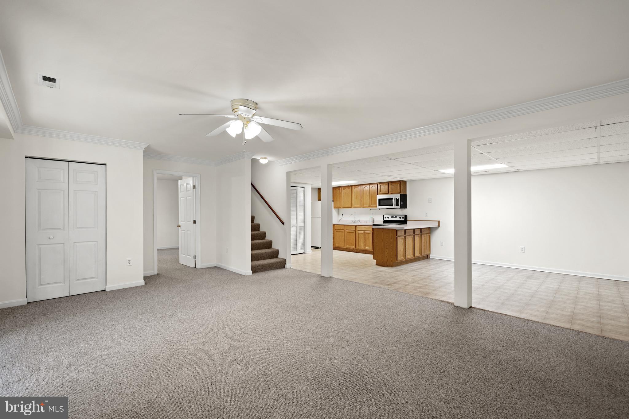 6251 Stephen Reid Road Huntingtown, MD 20639 - Photo 26 of 46 a view of a kitchen with furniture and a ceiling fan