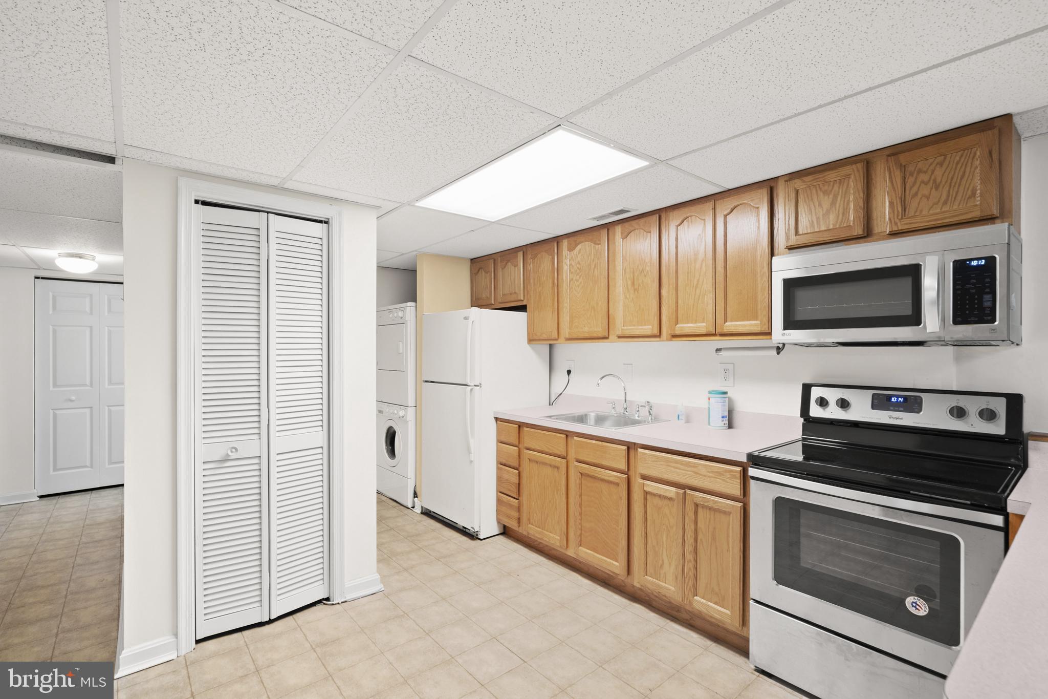 6251 Stephen Reid Road Huntingtown, MD 20639 - Photo 29 of 46 a kitchen with stainless steel appliances granite countertop white cabinets a stove a microwave and a refrigerator