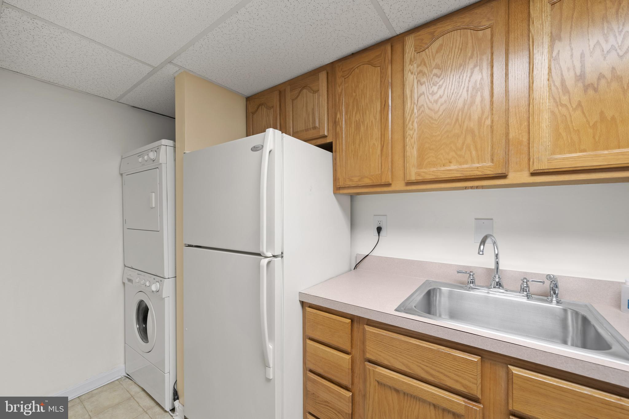 6251 Stephen Reid Road Huntingtown, MD 20639 - Photo 30 of 46 a white refrigerator freezer sitting in a kitchen with stainless steel appliances granite countertop cabinets and a refrigerator
