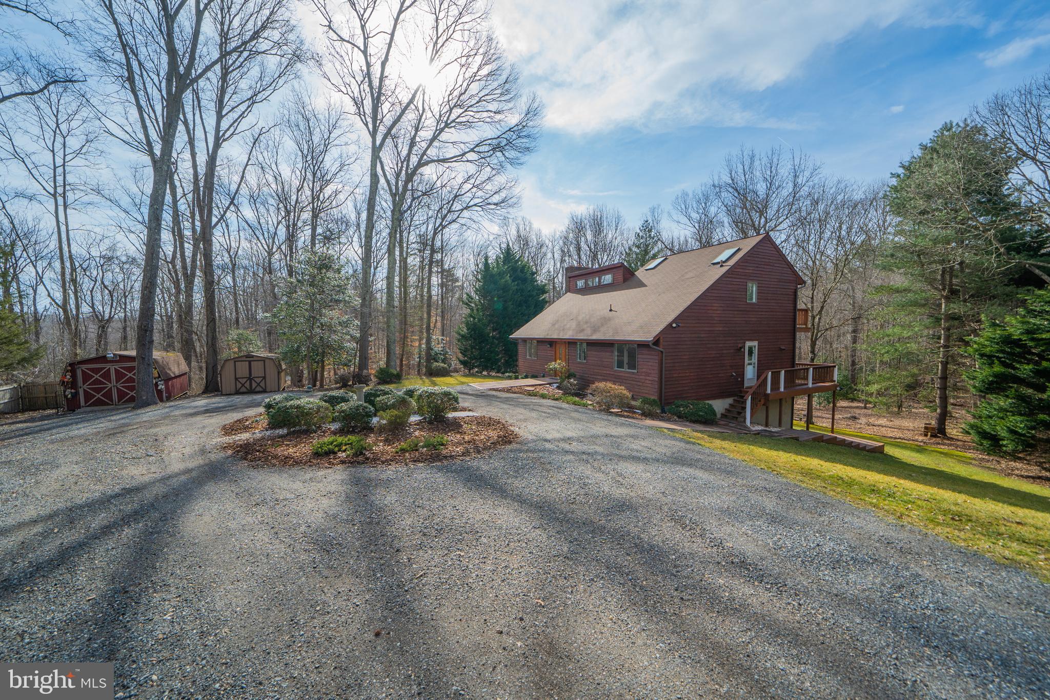 6251 Stephen Reid Road Huntingtown, MD 20639 - Photo 42 of 46 a view of a house with a big yard and large trees