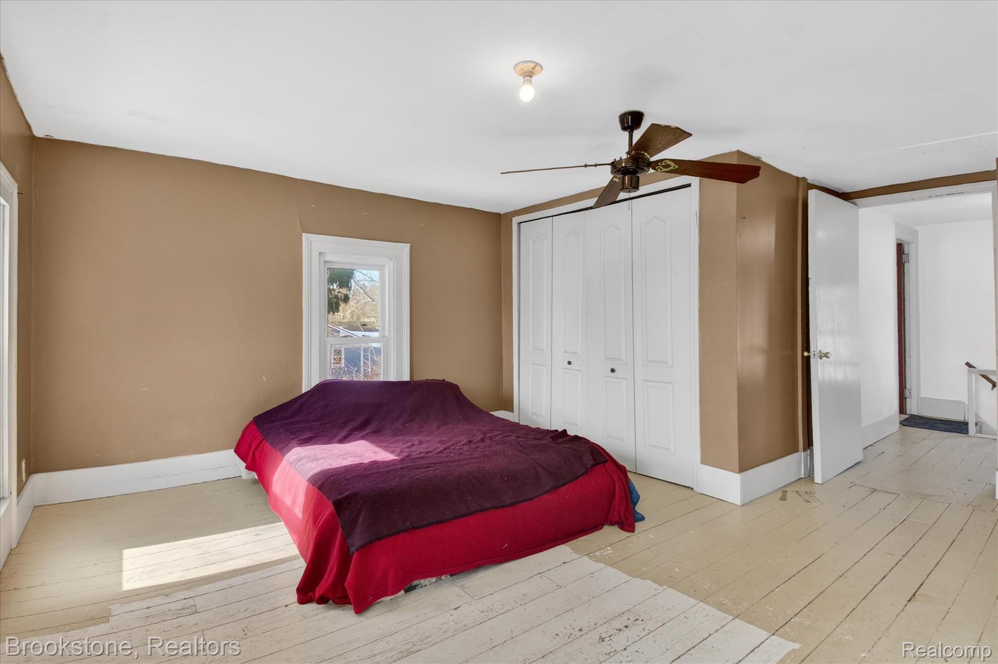 6756 West Beard Road Perry, MI 48872 - Photo 16 of 32 Bedroom with hardwood / wood-style flooring, a ceiling fan, and a closet