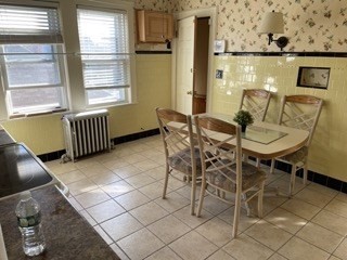 123 St Andrew Road, Unit 2 Boston, MA 02128 - Photo 4 of 8 a view of a dining room with furniture and a window