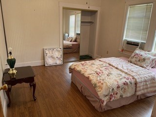 123 St Andrew Road, Unit 2 Boston, MA 02128 - Photo 5 of 8 a bedroom with a bed and wooden floor