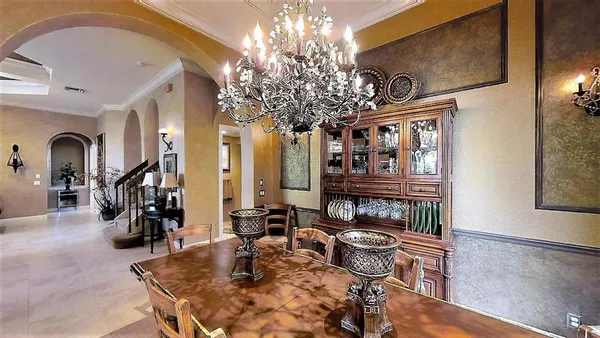 a lobby with furniture and chandelier