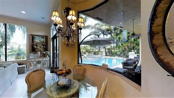 a living room with furniture and a large mirror