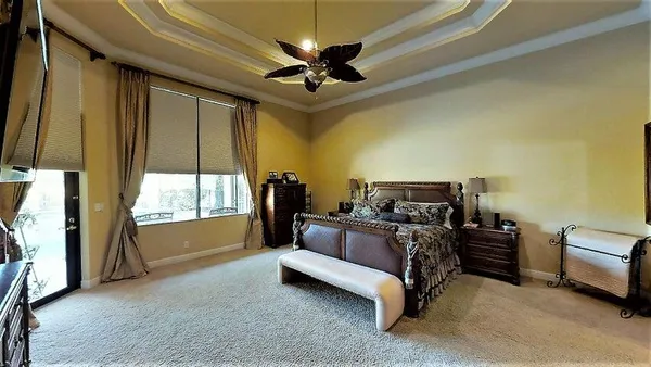 a bed room with a bed and a chandelier