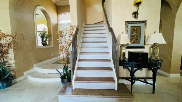 a view of entryway and hall with wooden floor