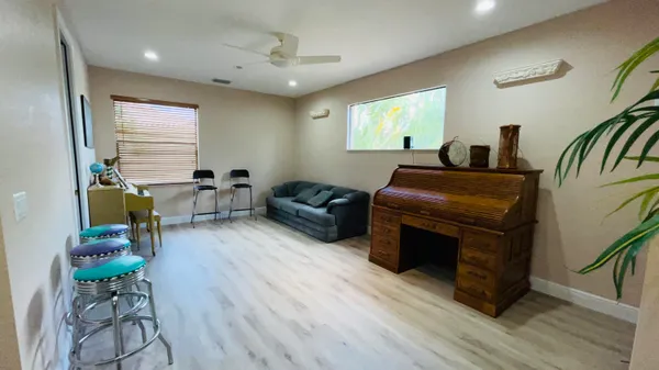 a living room with furniture and a wooden floor