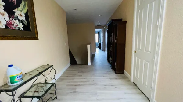 a view of hallway with wooden floor
