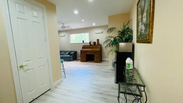 a living room with furniture and a wooden floor
