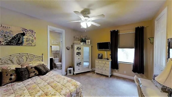 a bedroom with a bed closet and flat tv screen
