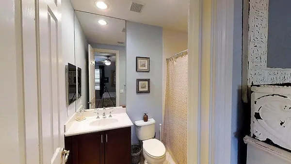 a bathroom with a sink vanity mirror and toilet