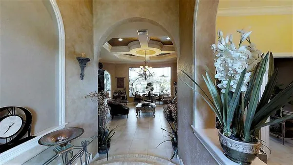 a living room with furniture a fireplace and potted plants