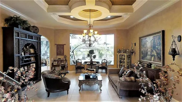 a living room with fireplace furniture and a chandelier