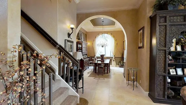a view of entryway and hall with dining room