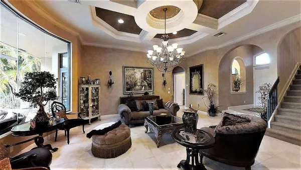 a living room with furniture a chandelier and a chandelier