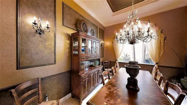 a view of living room filled with furniture and chandelier