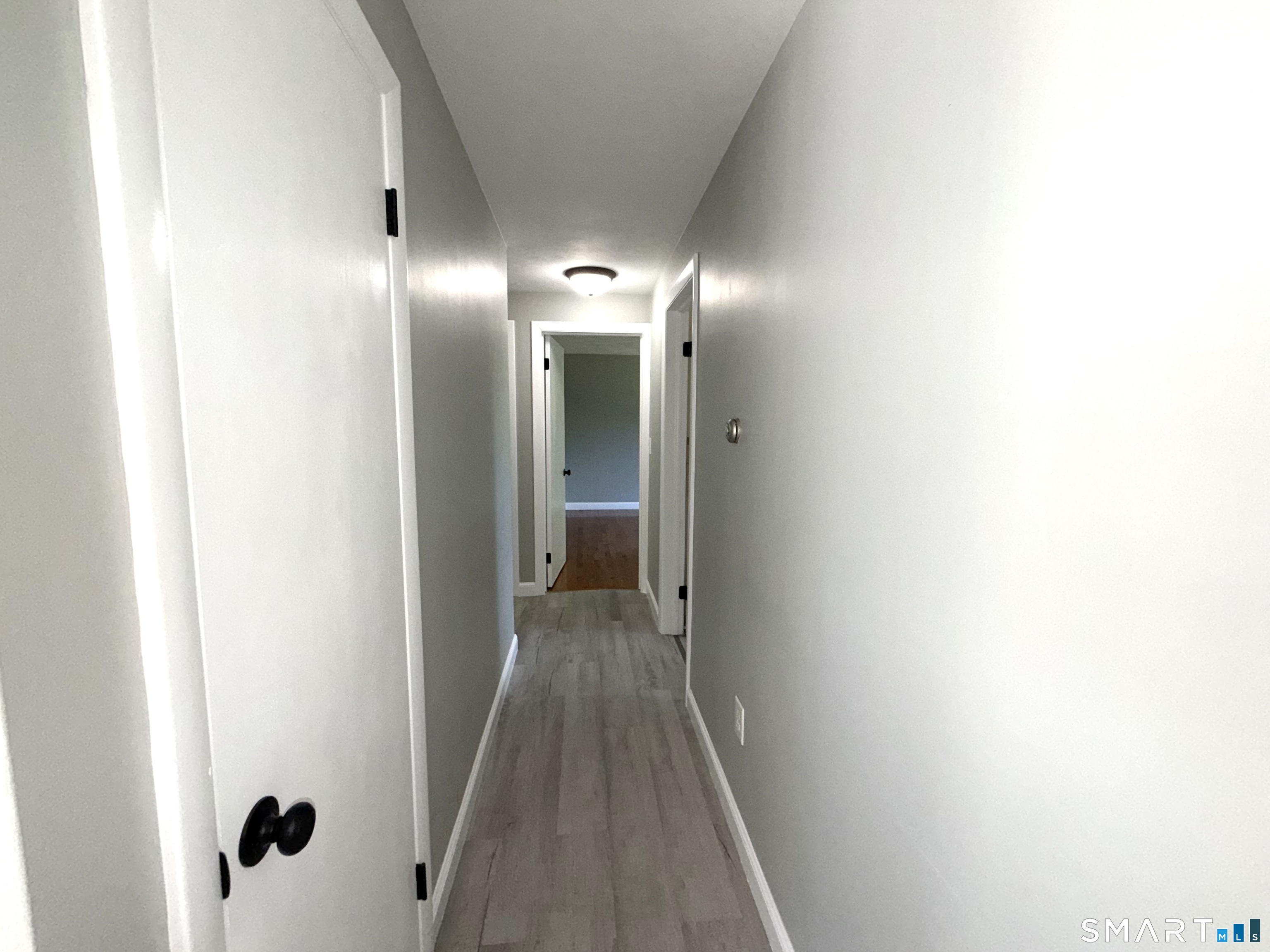 341 Harland Road Norwich, CT 06360 - Photo 10 of 29 a view of a hallway with wooden floor