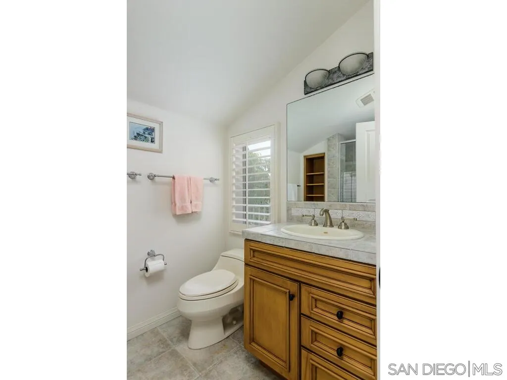 4 The Point Coronado, CA 92118 - Photo 37 of 50 a bathroom with a sink a toilet and mirror