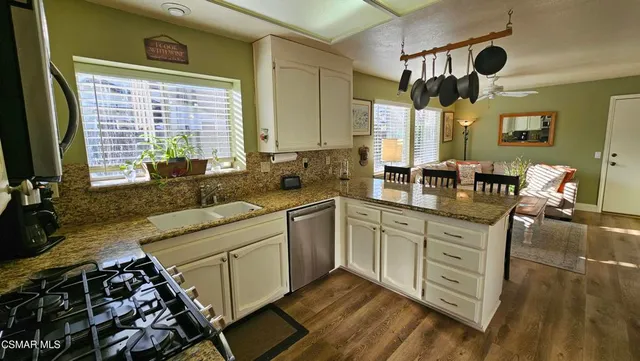 a kitchen with a stove a sink and a refrigerator