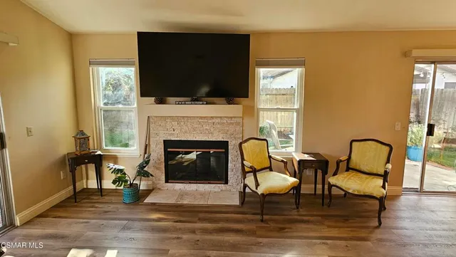 a living room with furniture fireplace and flat screen tv