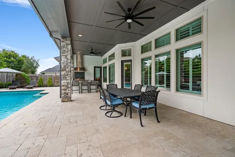 a view of a patio with table and chairs and a barbeque
