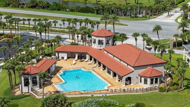 an aerial view of a house with garden space and street view