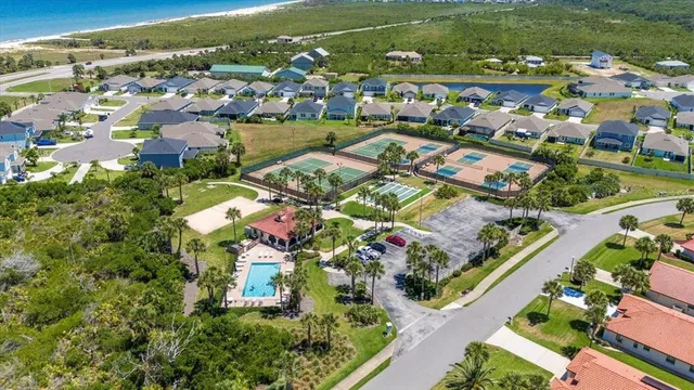 an aerial view of residential houses with outdoor space and river view