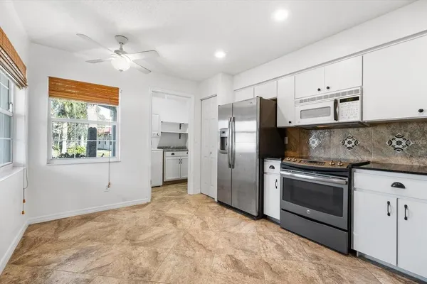 a kitchen with stainless steel appliances a stove a refrigerator sink and cabinets