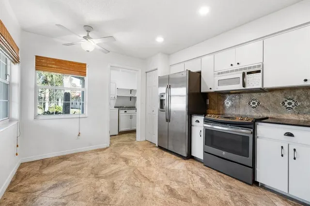 a kitchen with stainless steel appliances a stove a refrigerator sink and cabinets