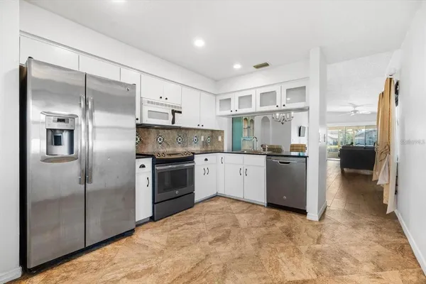 a kitchen with a refrigerator and a sink