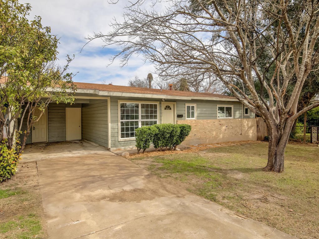 6001 Cameron Road Austin, TX 78723 - Photo 1 of 1 a front view of a house with a yard and garage