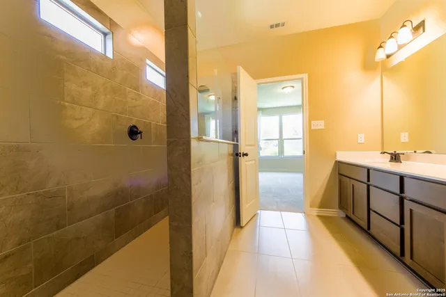 a bathroom with a mirror and a shower