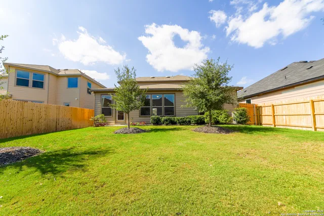 a view of house with backyard and garden
