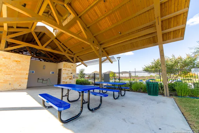 a building outdoor space with patio furniture and garden