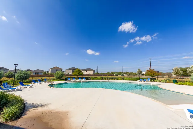 a view of a swimming pool and a yard