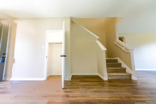 a view of entryway and hall with wooden floor