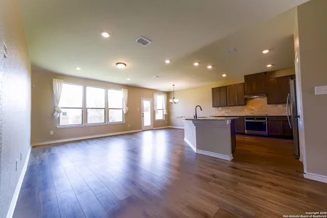a view of kitchen with cabinets and wooden floor